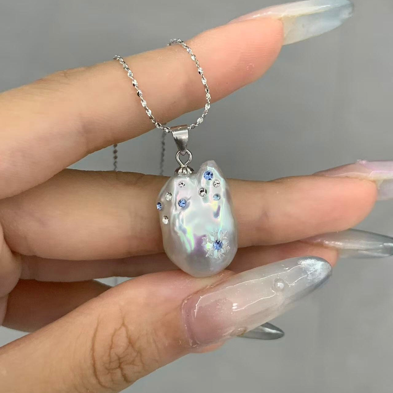 【Pearlish】First Flurries · Handcrafted inlaid and carved jewelry pendant featuring a natural freshwater baroque pearl set in a sterling silver base. A niche artisanal collectible, perfect as a gift.