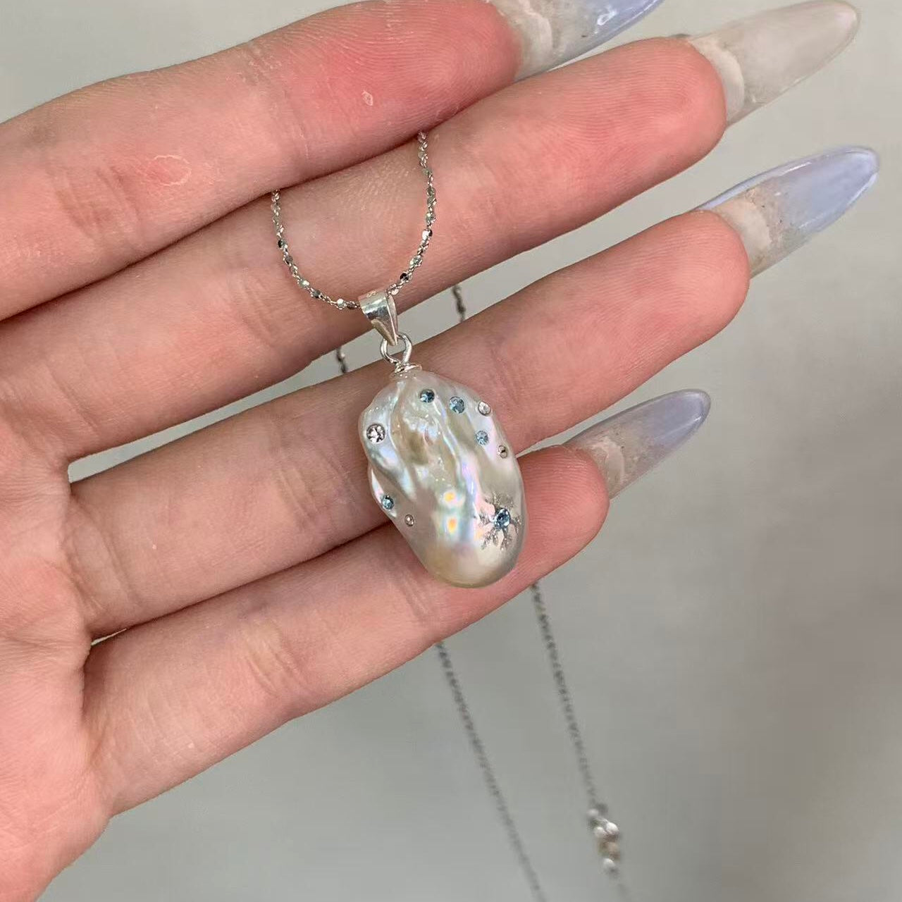 【Pearlish】First Flurries · Handcrafted inlaid and carved jewelry pendant featuring a natural freshwater baroque pearl set in a sterling silver base. A niche artisanal collectible, perfect as a gift.