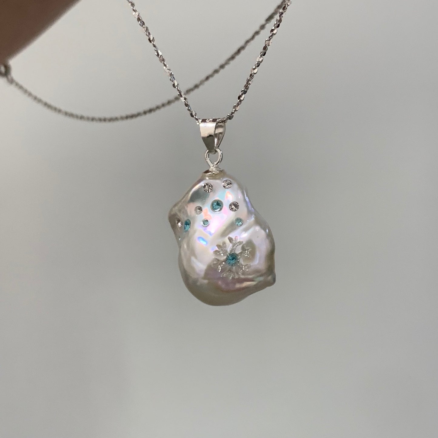 【Pearlish】First Flurries · Handcrafted inlaid and carved jewelry pendant featuring a natural freshwater baroque pearl set in a sterling silver base. A niche artisanal collectible, perfect as a gift.